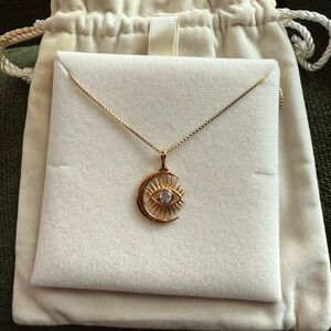 14k yellow gold vermeil with white topaz stone in center. Evil eye and moon